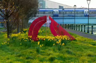 A RED METAL YOKE BY BOB SLOAN [THIS SCULPTURE IN BELFAST HAS NO NAME]-203537-1