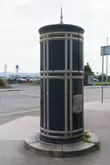 A FREESTANDING FINIAL-TOPPED CAST-IRON TRANSFORMER [DATING FROM 1900 AND LOCATED AT CONQUER HILL ROAD NEAR CLONTARF BUS GARAGE]-244416-1