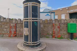 A FREESTANDING FINIAL-TOPPED CAST-IRON TRANSFORMER [DATING FROM 1900 AND LOCATED AT CONQUER HILL ROAD NEAR CLONTARF BUS GARAGE]-244412-1