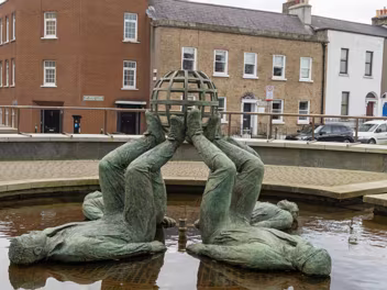 WHO MADE THE WORLD "Who Made the World" is a bronze sculpture depicting four male figures lying on their backs, their legs and feet...