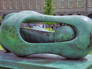 SCULPTURE BY HENRY MOORE Henry Moore's bronze sculpture, "Reclining Connected Form," created in 1969, holds a prominent position in Library...