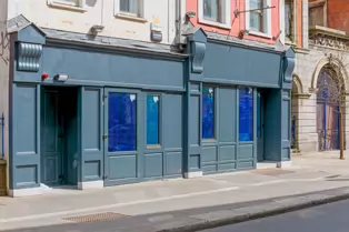 AT LONG LAST THE BUILDING HAS BEEN RESTORED [DROP DEAD TWICE WAS DESTROYED IN A FIRE IN 2022]-249580-1