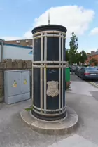 A FREESTANDING FINIAL-TOPPED CAST-IRON TRANSFORMER [DATING FROM 1900 AND LOCATED AT CONQUER HILL ROAD NEAR CLONTARF BUS GARAGE]-244414-1