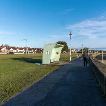 THE WIND SHELETER THE WIND SHELTERS AND THE BANDSTAND ALONG CLONTARF PROMENADE [REMAIN AS A TRIBUTE TO HERBERT SIMMS]